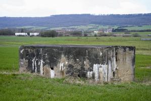 Ligne Maginot - CB314 - (Blockhaus pour arme infanterie) - Vue latérale du bloc. L'entrée est sur cette face.
Le village d'Oeutrange est en arrière-plan dominé par la falaise sur laquelle se trouve les blocs de l'ouvrage de Molvange.