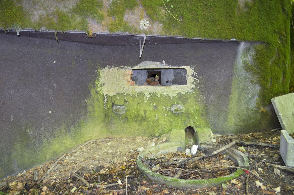 Ligne Maginot - 108 - STRENGWALD NORD - (Casemate d'infanterie - Double) - Créneau mitrailleuse, on remarque derrière les pierres le volet blindé, et au sol la fosse à douille dans laquelle débouche l'évacuation des douilles. - D. Froehly