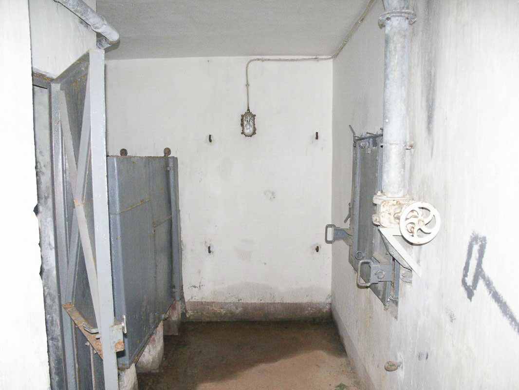 Ligne Maginot - LAVOIR - (Ouvrage d'artillerie) - Bloc 2
Etage intermédiaire
A droite, la trappe de la fosse de récupération des douilles
A gauche, les latrines et au fond le réservoir d'eau - JOLAS, Jean-Michel